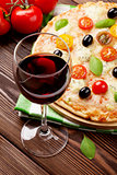 Glass of red wine and italian pizza
