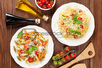 Spaghetti and penne pasta with tomatoes and basil