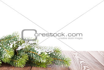 Christmas tree branch on wooden table