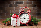Christmas gift box, alarm clock and tree branch