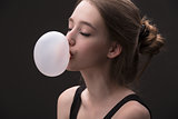 brown-haired girl with bubble of chewing gum