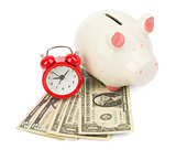Piggy bank with dollars and alarm clock
