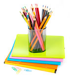 Pencil cup with crayons and clips on copybooks