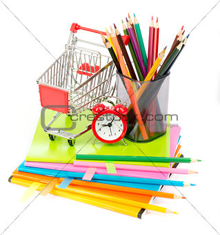 Shopping cart with copybooks and alarm clock