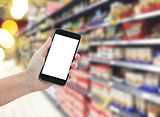 hand holding a modern smartphone in supermarket
