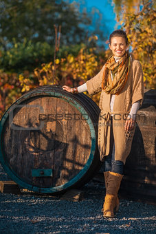 Full length portrait of woman standing in autumn vineyard