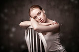 beautiful woman sitting on a white chair