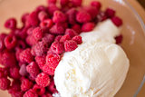 Delicious dessert of raspberries and ice cream.