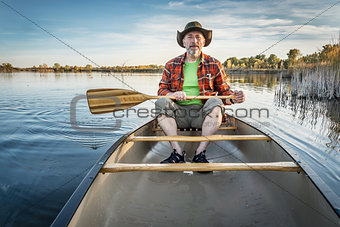 canoeing on a calm lake in fall