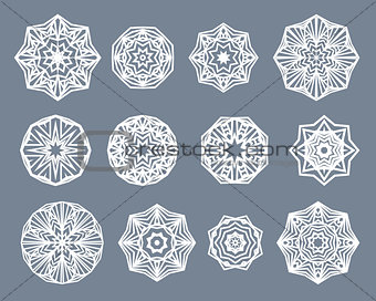 Mandalas set. White snowflakes isolated on gray