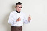 Mature Asian chef thumbs up