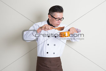 Mature Asian Chinese chef cooking food
