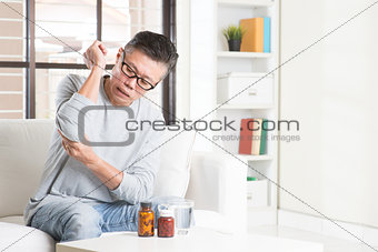 Mature Asian man elbow pain