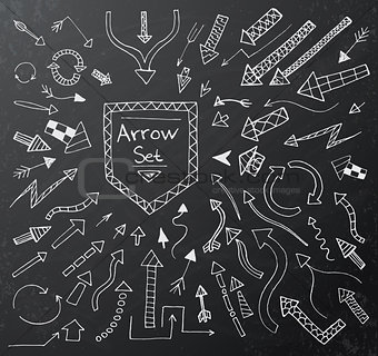 Hand drawn arrow icons set on black chalk board