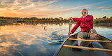 paddling canoe at sunset