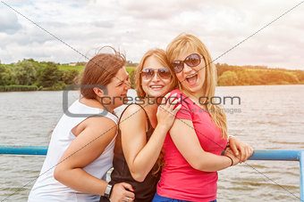 Group of friends having fun outdoors on a lake