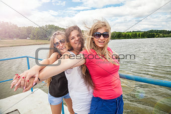Group of friends having fun outdoors on a lake