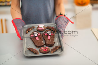 Closeup on tray with Halloween cookies in hands of housewife