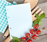 Blank notepad paper for your recipes with tomatoes and basil