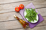 Arugula salad, tomatoes and olive oil bottle