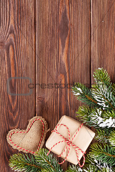 Christmas tree branch with gift box and heart toy
