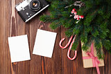 Blank photo frames with gift, pine tree and camera