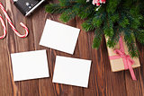 Blank photo frames with gift, pine tree and camera