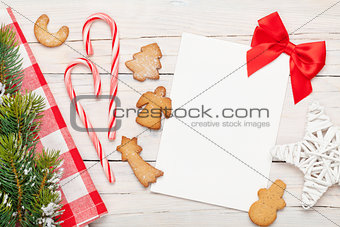 Christmas greeting card, gingerbread cookies and snow fir tree