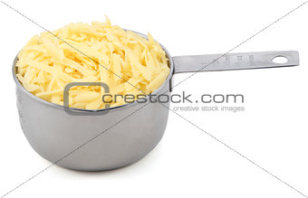 Shredded cheese in a measuring cup