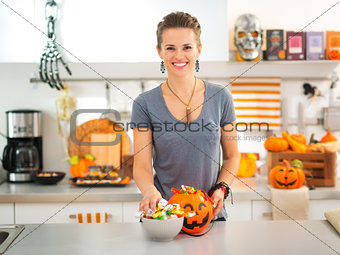 Woman preparing trick or treat candy for Halloween party
