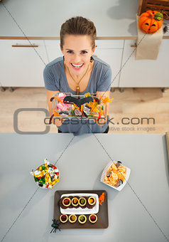 Woman showing horribly tasty treats for halloween party