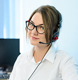 Young Attractive Smiling Customer Support Phone Operator with Headset in Office.