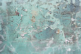 Green concrete cracked painted wall, damaged surface