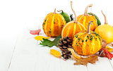 Autumnal pumpkins with yellow leaves
