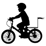A boy rides a bicycle with flag