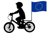 A kid rides a bicycle with European Union flag
