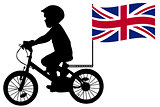 A kid silhouette rides a bicycle with United Kingdom flag