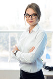 Young Attractive Smiling Businesswoman in White in Bright Modern Office