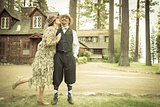 1920s Dressed Romantic Couple in Front of Old Cabin
