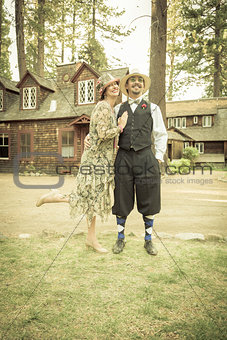 1920s Dressed Romantic Couple in Front of Old Cabin