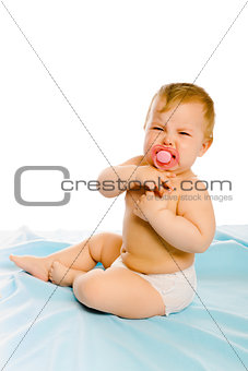 upset baby in diapers. Studio