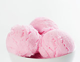 Pink ice cream in bowl with copy space on top