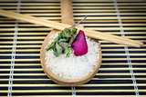 Rice on wooden spoon with wooden chopsticks