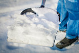 Man with a snow shovel in the hands of