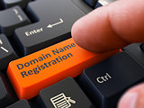Finger Presses Orange Keyboard Button Domain Name Registration.