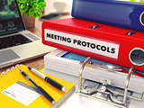 Meeting Protocols on Red Office Folder. Toned Image.