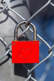 Red heart lock with a fence