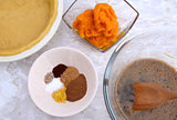 Making pumpkin pie - pastry crust, pumpkin, spices and filling