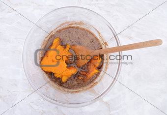 Stirring pureed pumpkin into pie filling