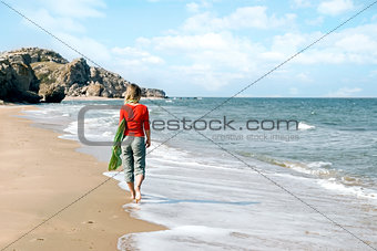 Young woman walking on a beach